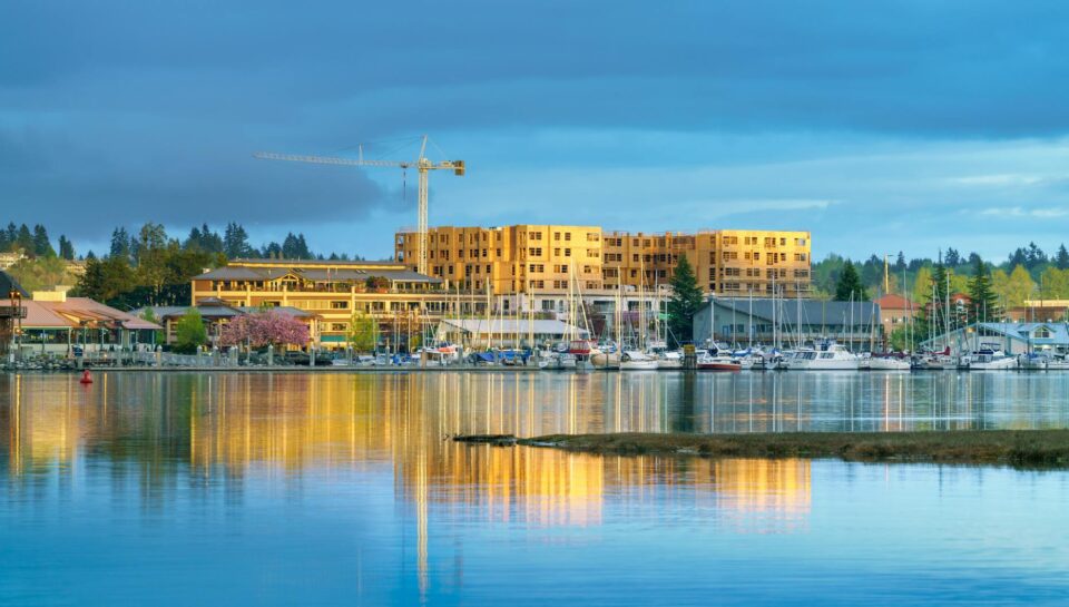 blue and yellow image of waterfront with boats and construction site